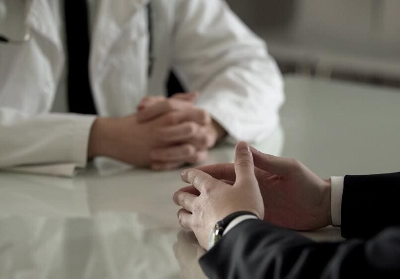 Two people having a serious discussion at a table.