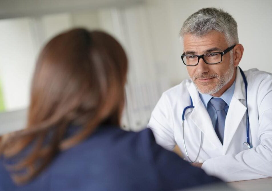 Doctor consulting with a patient in a medical office.