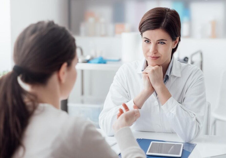 A doctor attentively listens to a patient during a consultation.