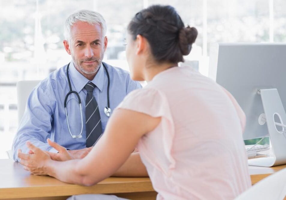 Doctor attentively listens to a patient during consultation.