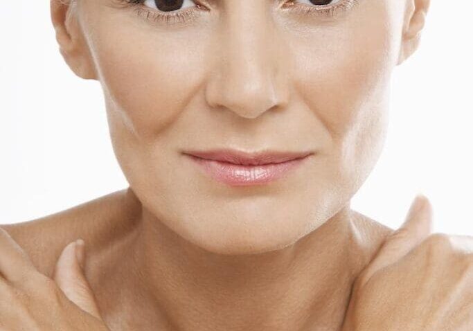 Close-up of a mature woman with natural makeup and a calm expression.