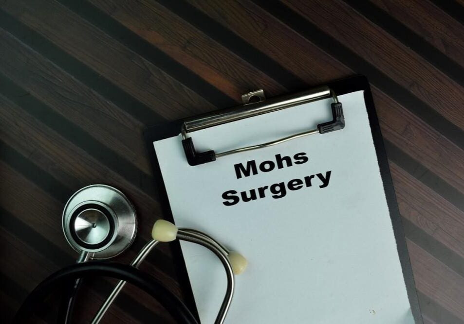 Clipboard with 'Mohs Surgery' text and a stethoscope on a wooden surface.